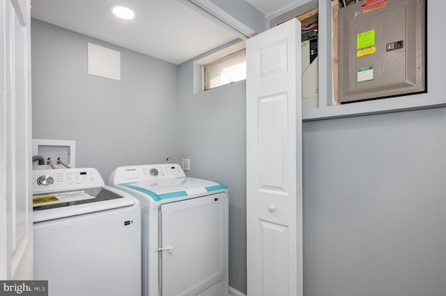 clothes washing area featuring separate washer and dryer and electric panel