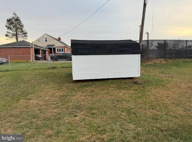 yard at dusk featuring a shed