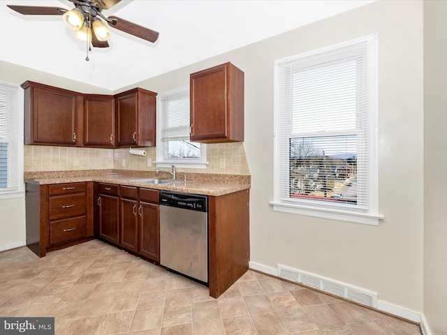 kitchen with tasteful backsplash, sink, stainless steel dishwasher, and ceiling fan