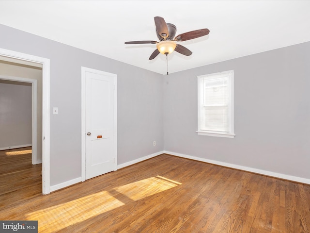 spare room featuring hardwood / wood-style flooring and ceiling fan