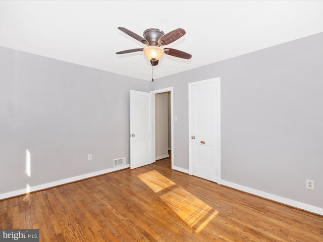 unfurnished room with ceiling fan and wood-type flooring