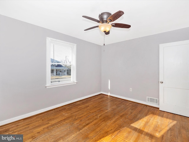 spare room with hardwood / wood-style floors and ceiling fan