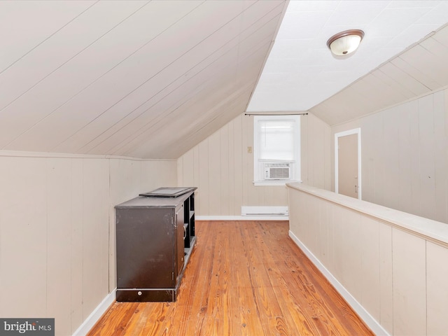 bonus room featuring lofted ceiling, a baseboard heating unit, cooling unit, and light wood-type flooring