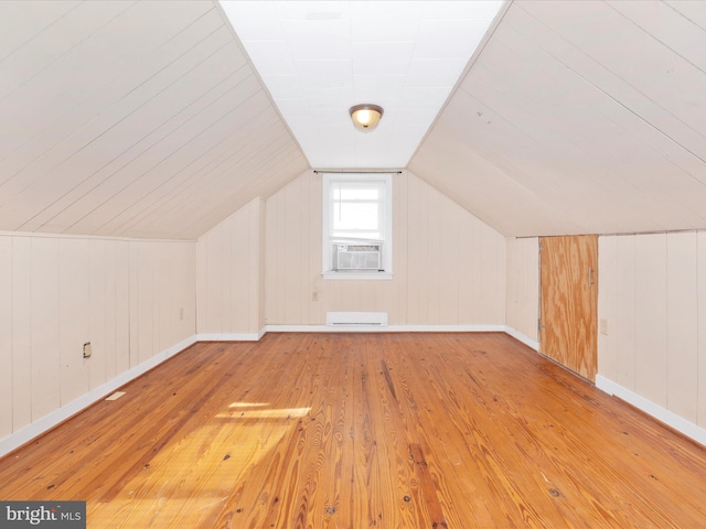 bonus room featuring vaulted ceiling, baseboard heating, and light hardwood / wood-style flooring