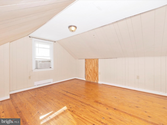 bonus room with lofted ceiling, a baseboard heating unit, hardwood / wood-style floors, and cooling unit