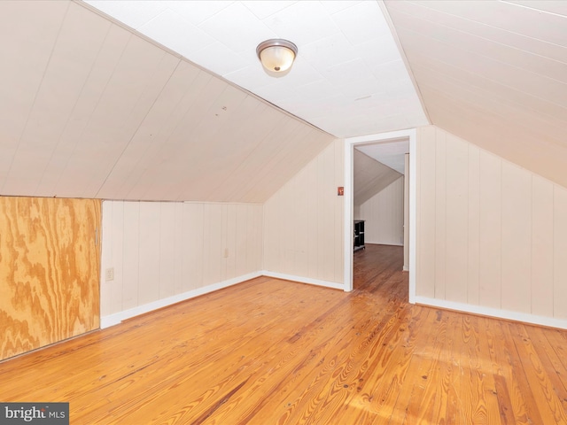 bonus room featuring lofted ceiling and hardwood / wood-style floors