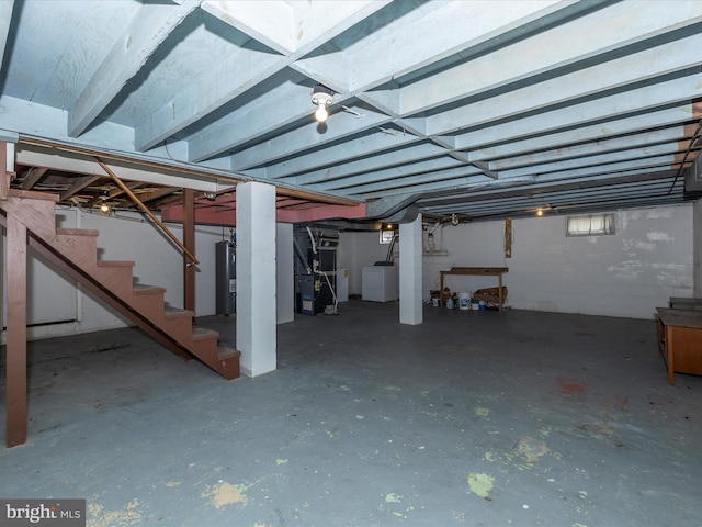 basement featuring water heater and heating unit