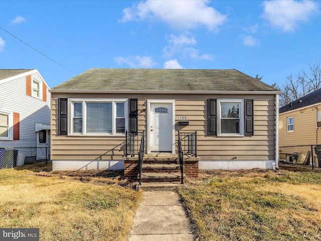 bungalow-style house with a front yard