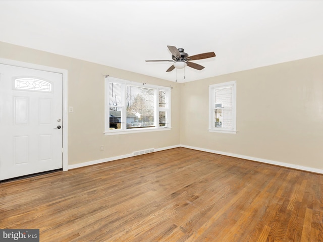 foyer entrance with ceiling fan and wood-type flooring