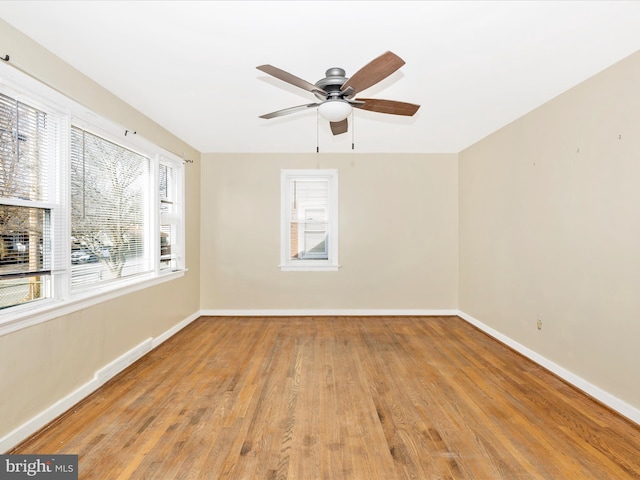 empty room with ceiling fan and light hardwood / wood-style floors