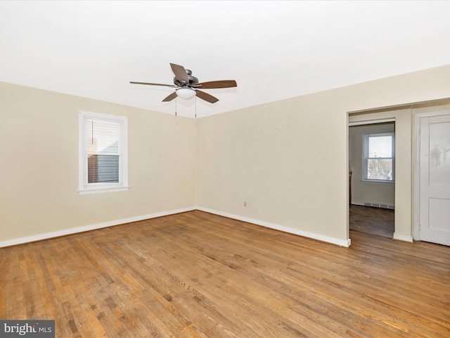 empty room with wood-type flooring and ceiling fan