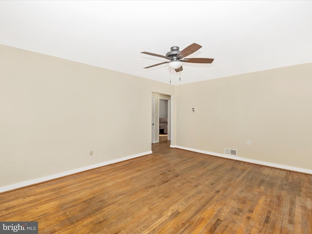 empty room with ceiling fan and wood-type flooring