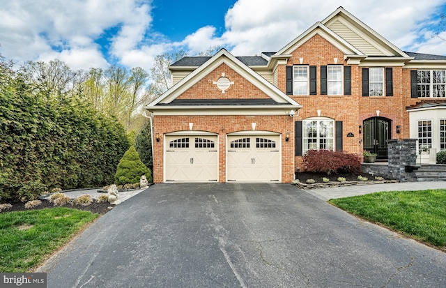 19 Longwood Ln, Newark, DE 19711 - view of front of house featuring brick siding, a garage, and aphalt driveway