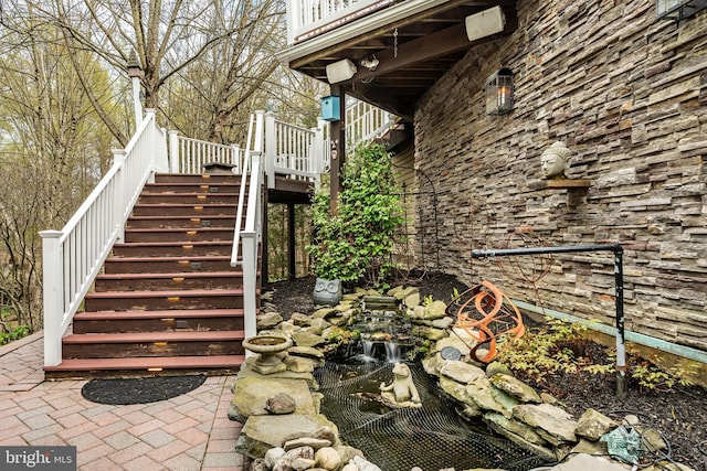 19 Longwood Ln, Newark, DE 19711 - exterior space with stairs, a small pond, and stone siding