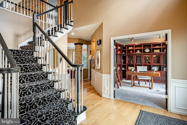 19 Longwood Ln, Newark, DE 19711 - staircase featuring a decorative wall, ornate columns, wood finished floors, and a wainscoted wall