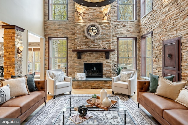 19 Longwood Ln, Newark, DE 19711 - living area with wood finished floors, a stone fireplace, and a towering ceiling