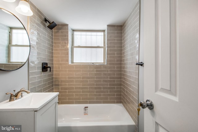 bathroom featuring vanity and tiled shower / bath