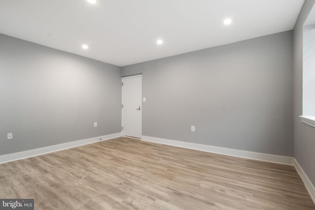 empty room with light hardwood / wood-style flooring