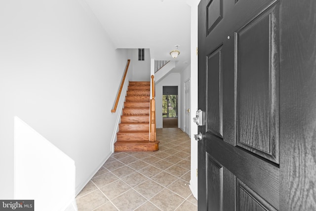 entryway with light tile patterned flooring