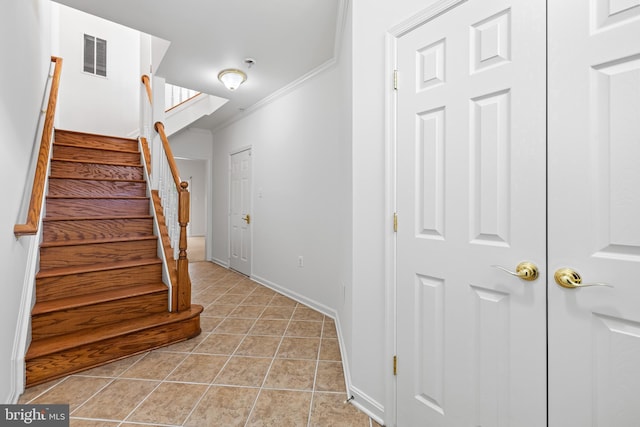 staircase with tile patterned flooring and ornamental molding