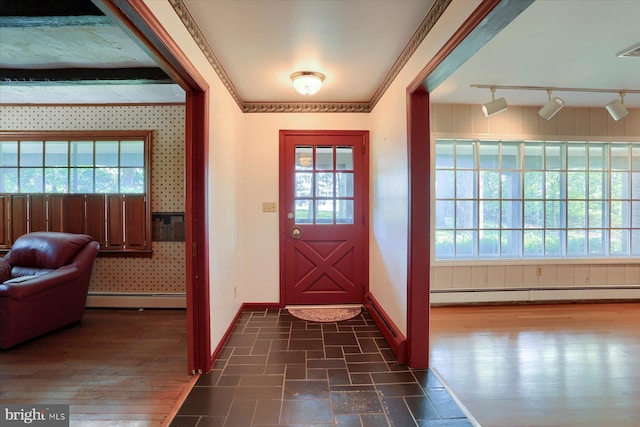 entrance foyer featuring crown molding, a wealth of natural light, and baseboard heating