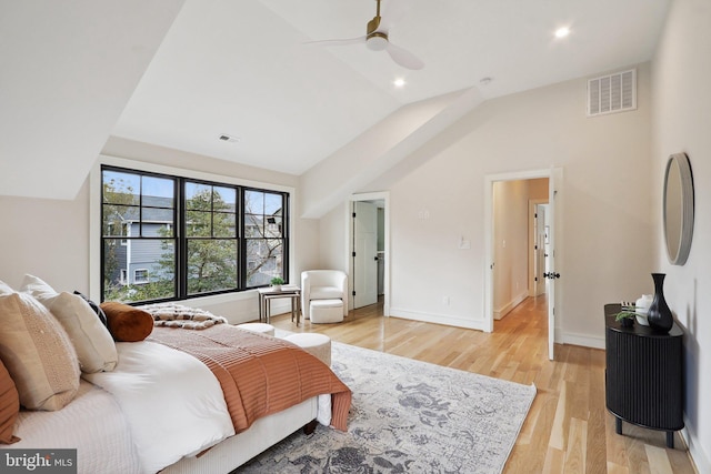 bedroom with a ceiling fan, lofted ceiling, visible vents, and light wood finished floors