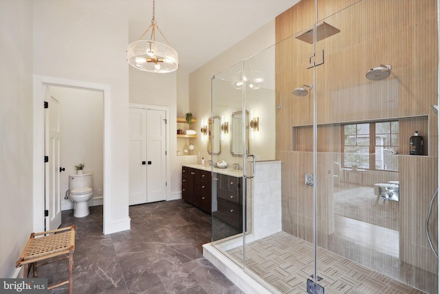 full bath with toilet, a high ceiling, vanity, baseboards, and a stall shower