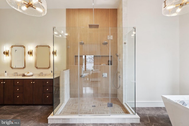 full bath with a freestanding bath, double vanity, a sink, and a shower stall