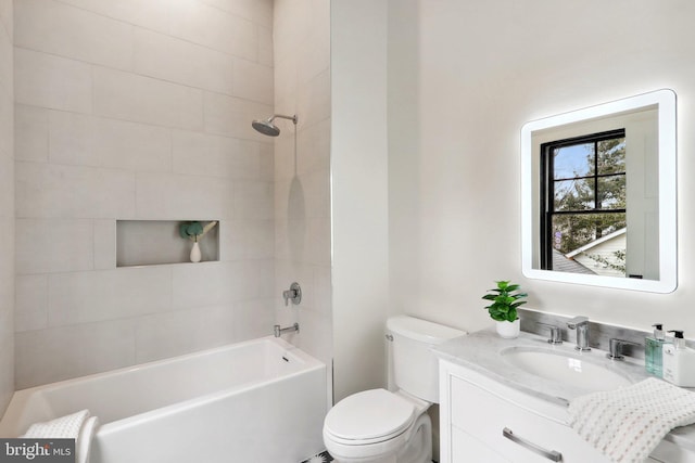 bathroom featuring toilet, washtub / shower combination, and vanity