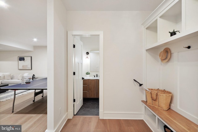 mudroom featuring baseboards and wood finished floors