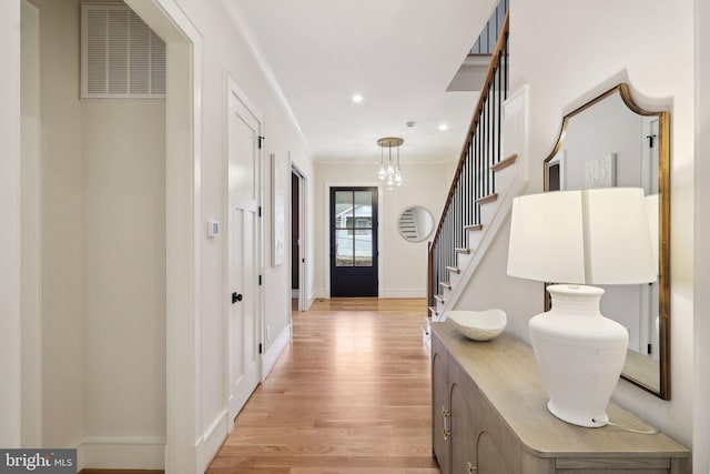 entrance foyer featuring visible vents, light wood-style flooring, stairs, crown molding, and recessed lighting