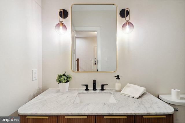 bathroom featuring toilet and vanity