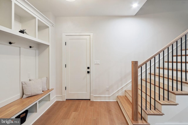 mudroom with baseboards and light wood finished floors