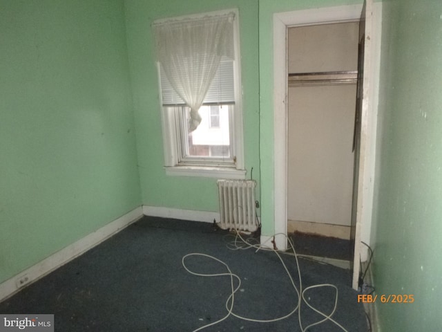 unfurnished bedroom with radiator heating unit