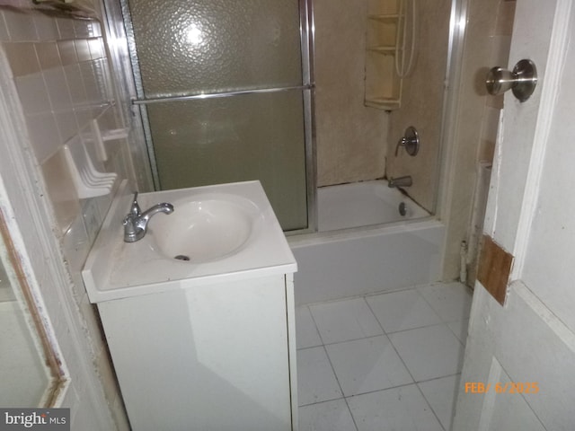 bathroom with tile patterned flooring, vanity, and combined bath / shower with glass door