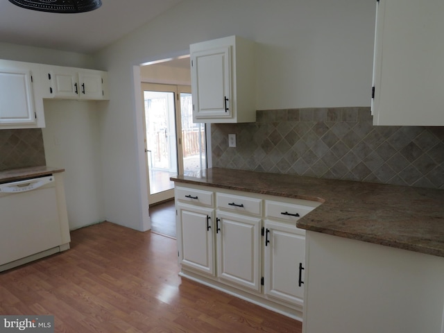 kitchen featuring lofted ceiling, white dishwasher, light hardwood / wood-style floors, and white cabinets