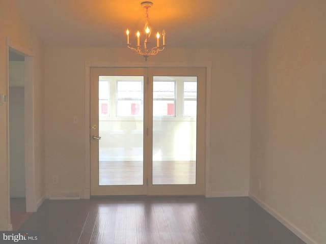 interior space featuring dark hardwood / wood-style flooring and a chandelier