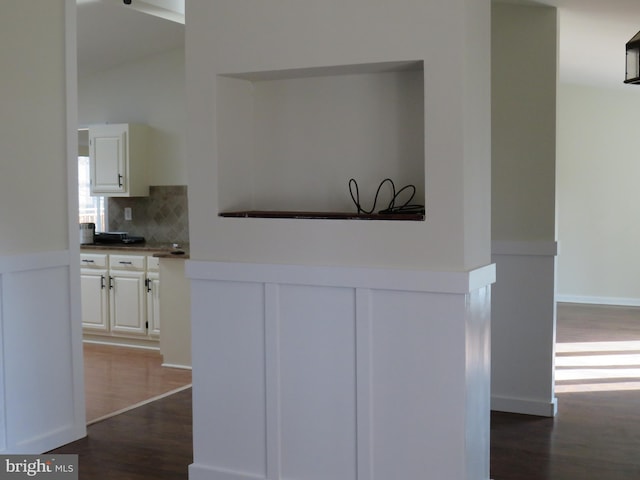 kitchen with tasteful backsplash, dark hardwood / wood-style floors, and white cabinets