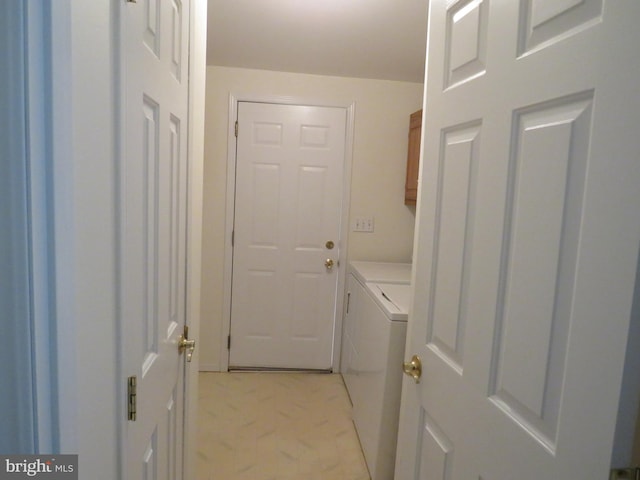 laundry room with cabinets and washer and clothes dryer