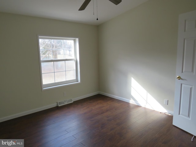 empty room featuring dark hardwood / wood-style floors and ceiling fan