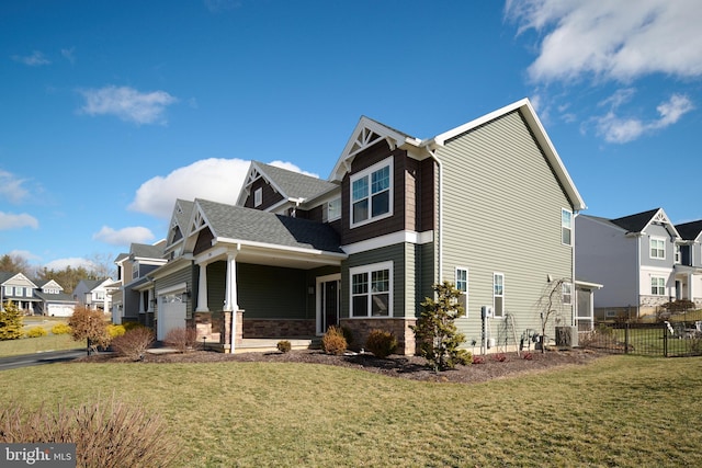 view of side of property with a garage, a yard, and central air condition unit