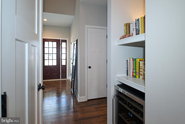 corridor with dark hardwood / wood-style floors and beverage cooler