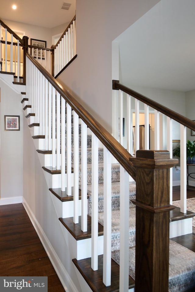 staircase with wood-type flooring