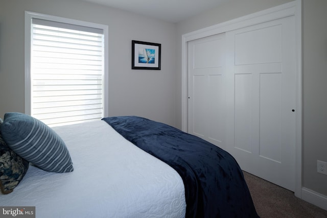 carpeted bedroom featuring a closet