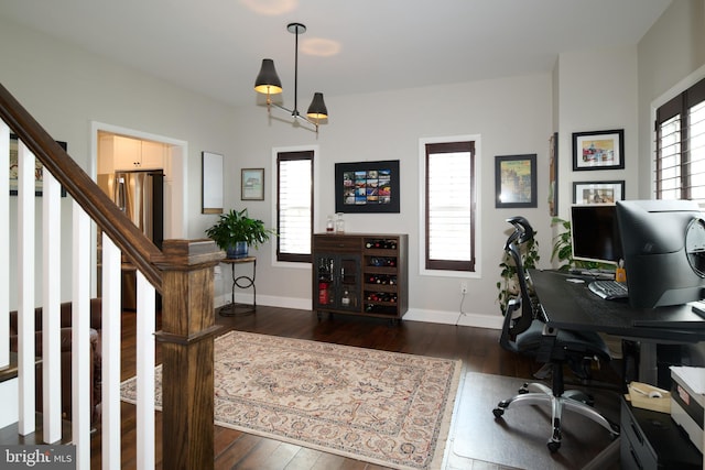 office space featuring a wealth of natural light and dark hardwood / wood-style floors