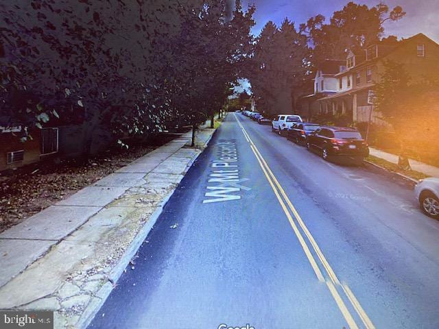 view of road with curbs and sidewalks