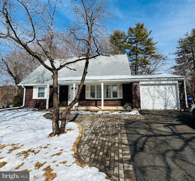 view of front of home featuring a garage, aphalt driveway, and a shingled roof