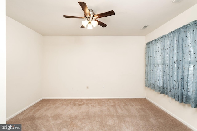 unfurnished room featuring light carpet, ceiling fan, visible vents, and baseboards