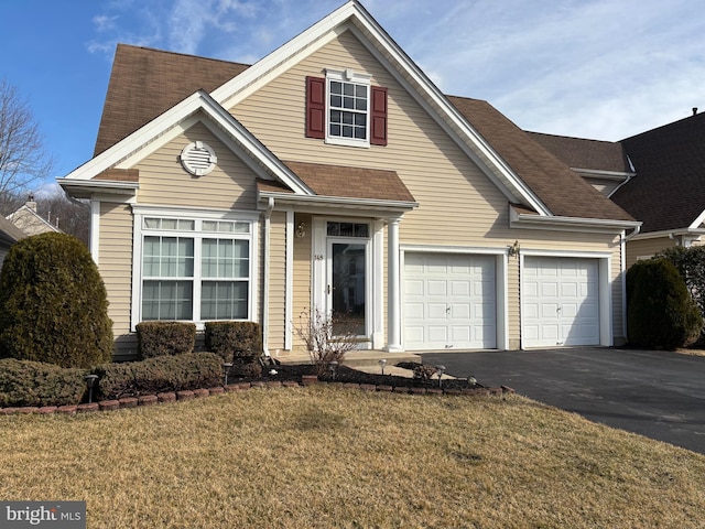 view of front of house featuring a garage and a front yard