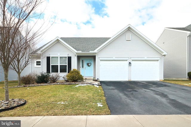 ranch-style home featuring a garage and a front yard